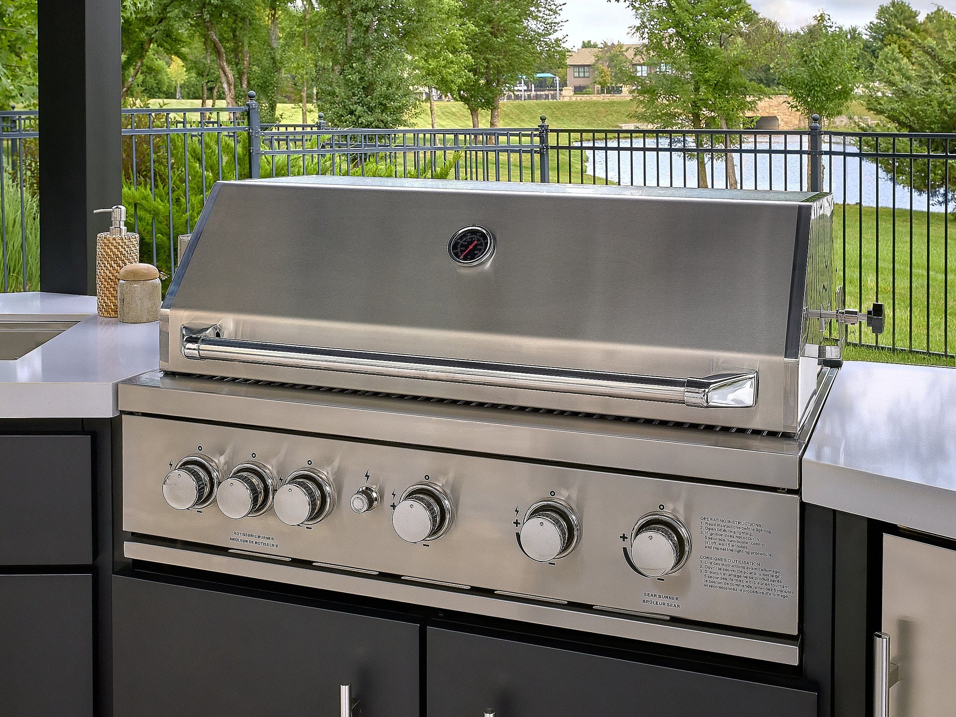 Edgemont Cove Outdoor Kitchen stainless steel drop-in sink with faucet off, set into white engineered stone countertop