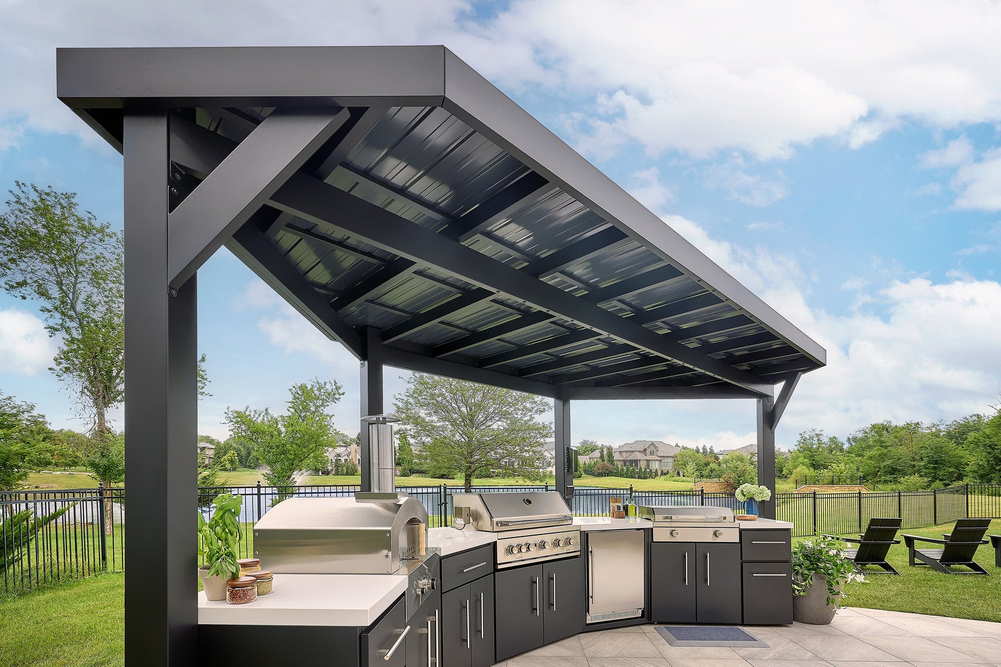 Edgemont Cove Outdoor Kitchen stainless steel drop-in sink with faucet running water, set into white engineered stone countertop