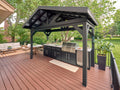 Lancaster Outdoor kitchen kit with black pavilion, built-in grill, sink, and cabinets with engineered stone countertop.