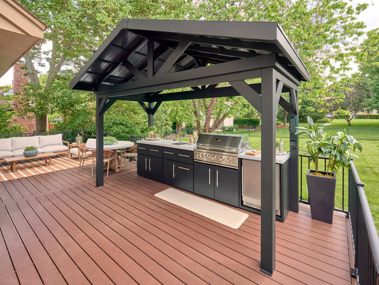 Lancaster Outdoor kitchen kit with black pavilion, built-in grill, sink, and cabinets with engineered stone countertop.