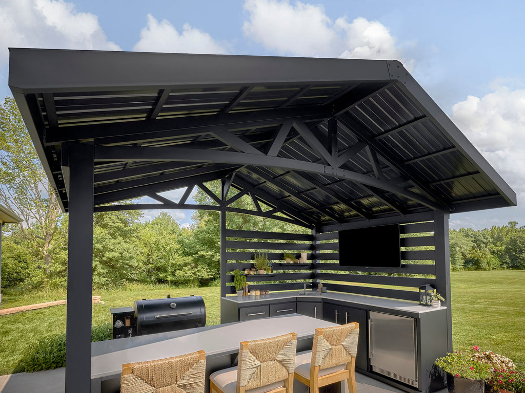 Range Outdoor Living Langston kitchen counters, bar seating, and grill in backyard.