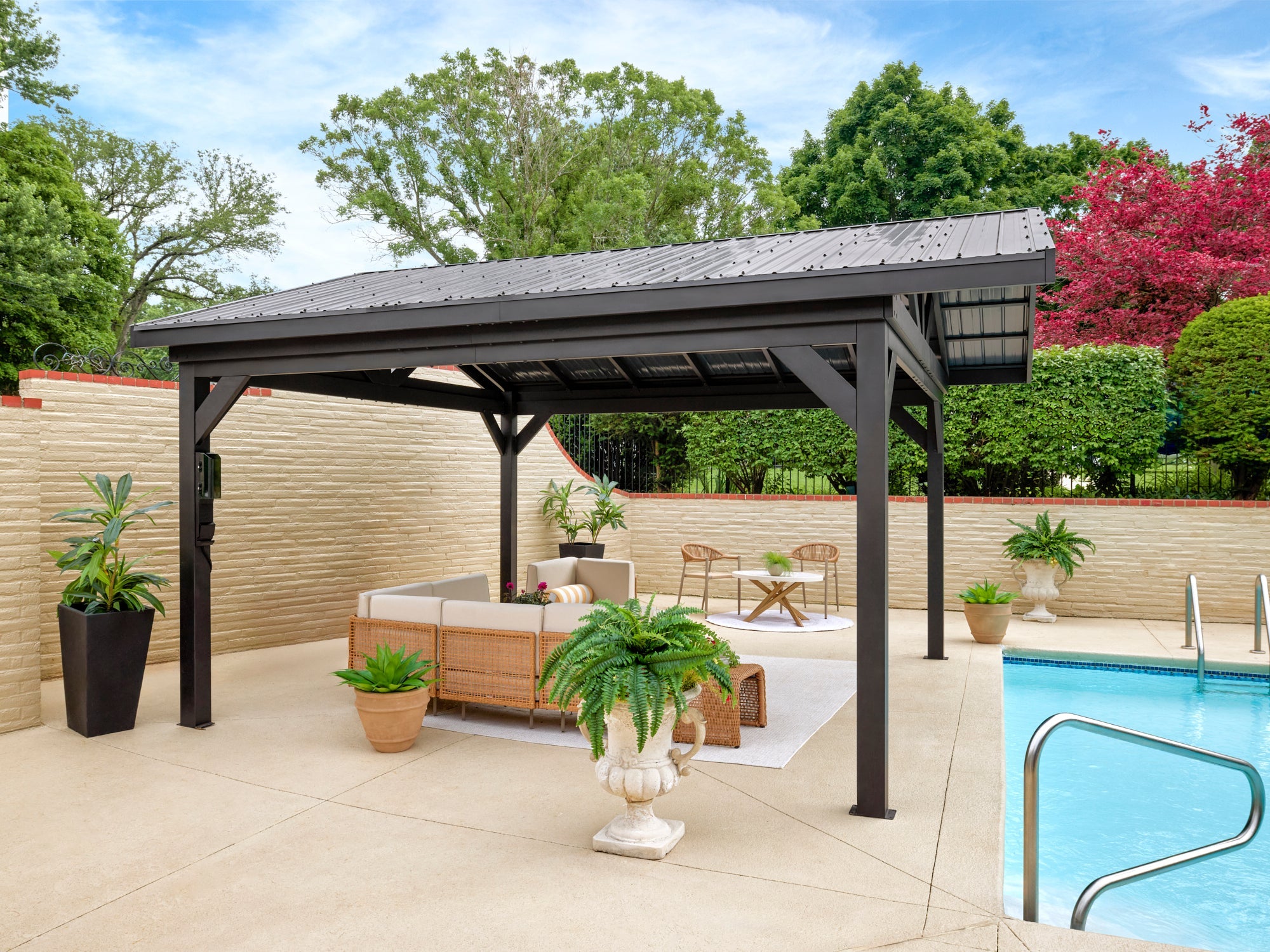 Steel Lancaster hardtop gazebo with metal roof providing backyard shade by swimming pool and privacy fence.