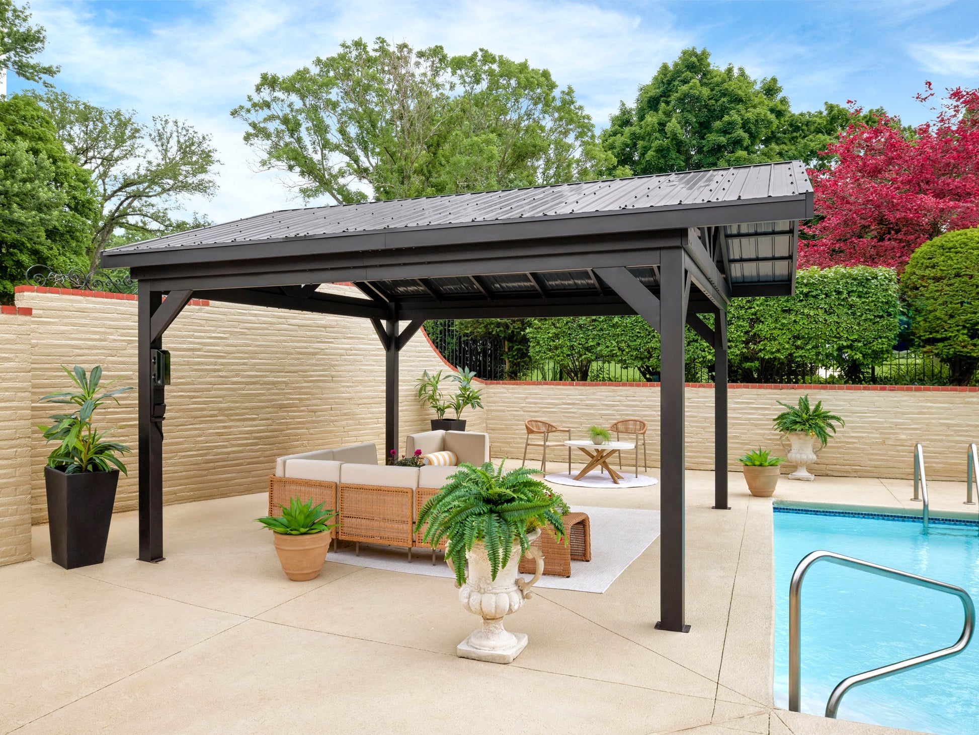 Steel Lancaster hardtop gazebo with metal roof providing backyard shade by swimming pool and privacy fence.
