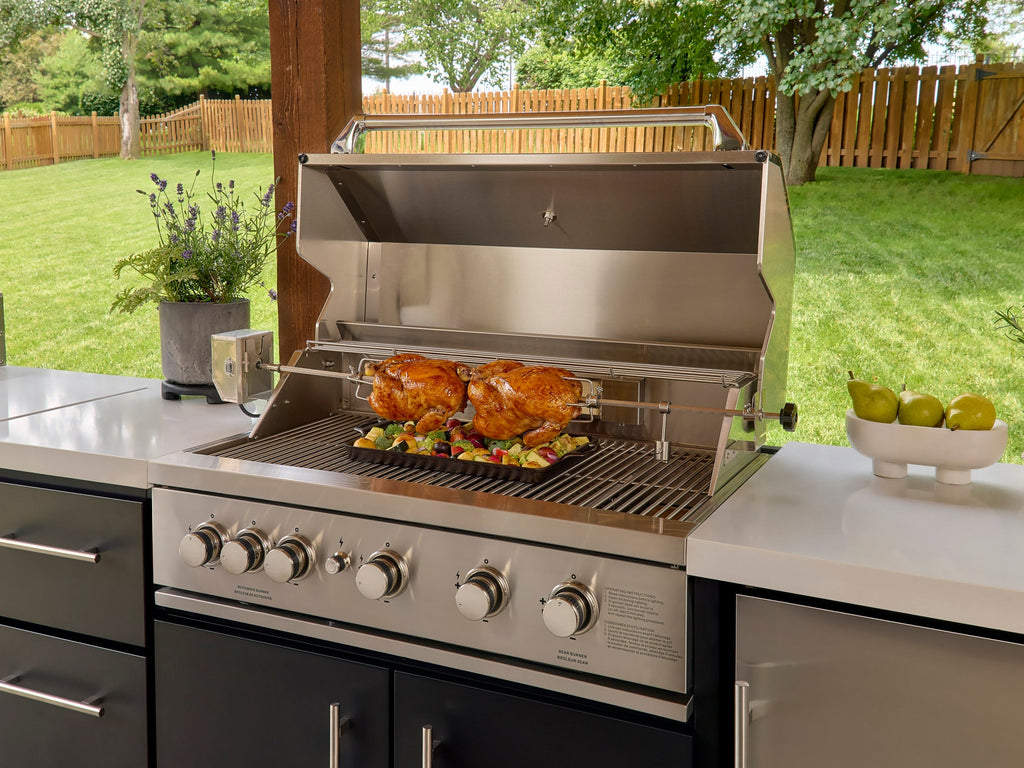Range Outdoor Living Emory kitchen grill with rotisserie chickens on bbq island with engineered stone countertop.